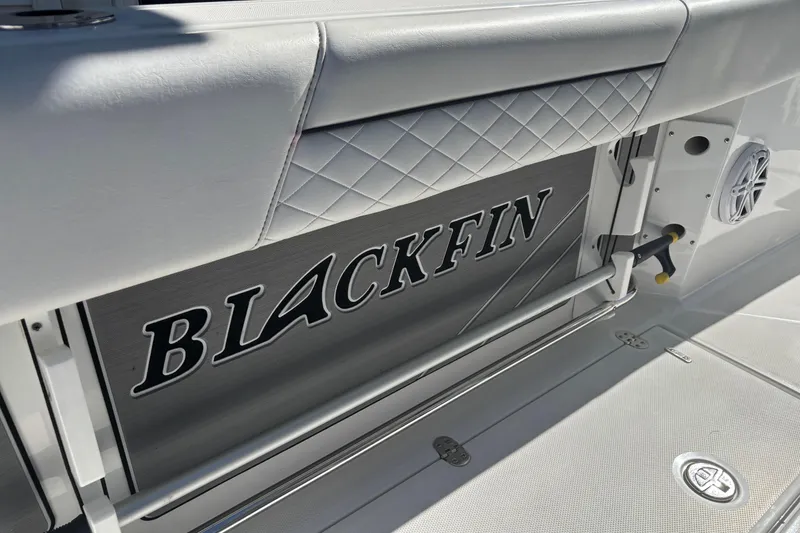 Slide: The Image of 2022 Blackfin 252 CC boat interior with logo and speaker detail. - 11