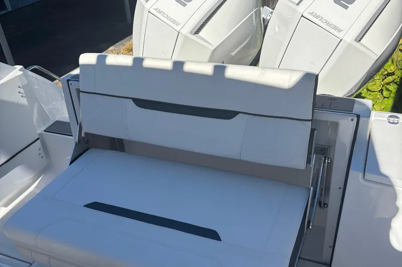 Slide: The Image of 2022 Blackfin 252 CC boat with white seating and dual Mercury engines. - 13