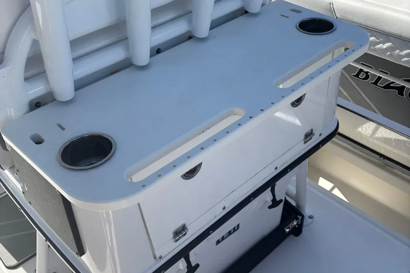 Slide: The Image of 2022 Blackfin 252 CC boat console with cup holders and storage compartment. - 15