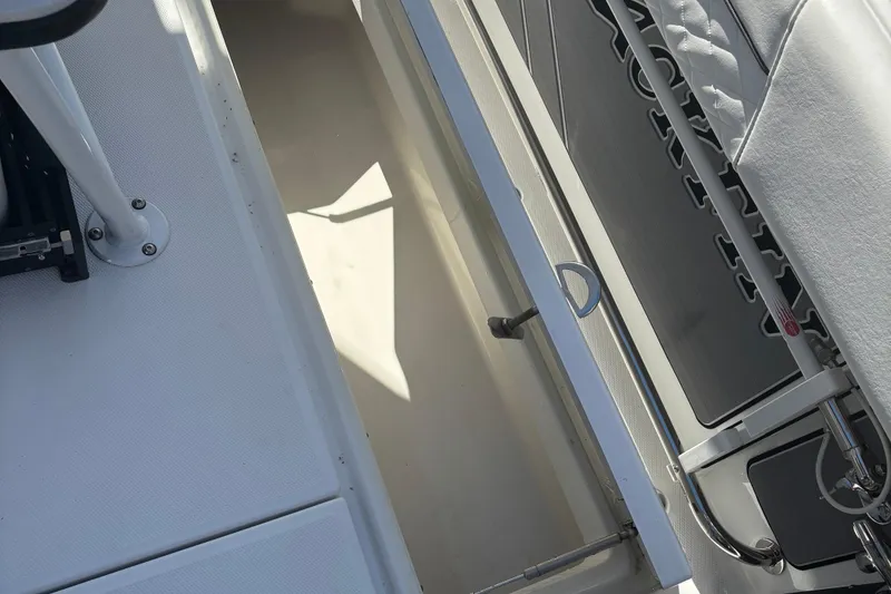 Slide: The Image of 2022 Blackfin 252 CC boat interior, showcasing storage compartment and seating area. - 16