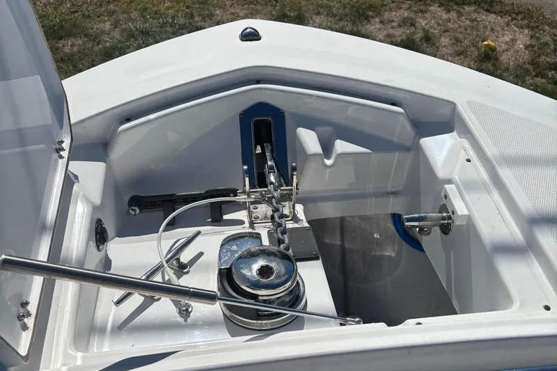 Slide: The Image of 2022 Blackfin 252 CC boat anchor compartment with winch and rope. - 19