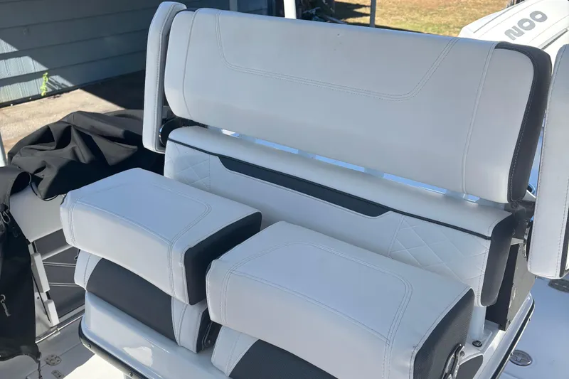 Slide: The Image of 2022 Blackfin 252 CC boat seating with white upholstery and black accents. - 20