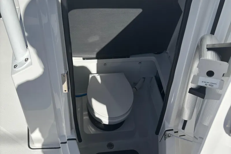 Slide: The Image of 2022 Blackfin 252 CC boat interior with compact marine toilet. - 23