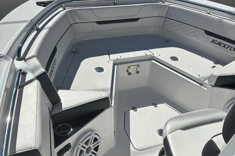 Slide: The Image of 2022 Blackfin 252 CC boat interior with cushioned seating and storage compartments. - 25