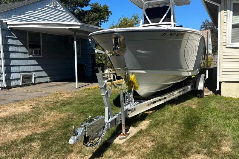 Slide: The Image of 2022 Blackfin 252 CC boat on trailer parked beside a house. - 4