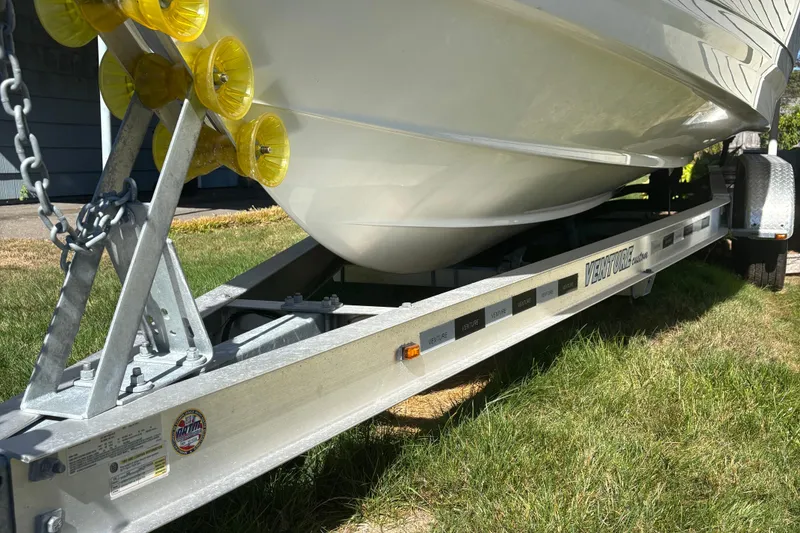 Slide: The Image of 2022 Blackfin 252 CC boat on Venture trailer, parked on grass. - 5