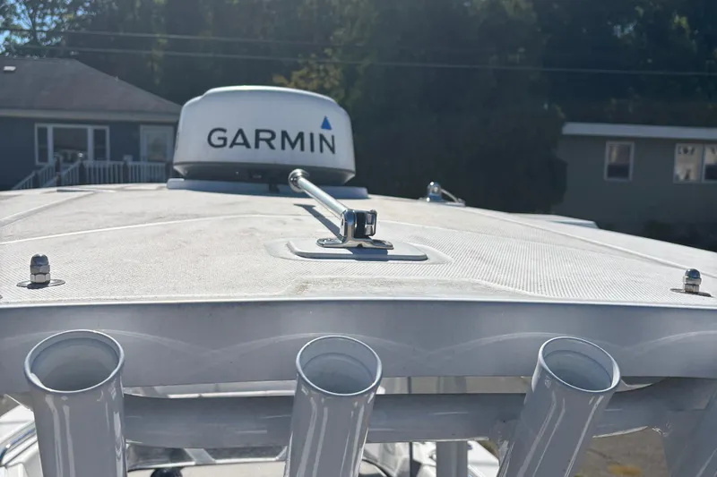 Slide: The Image of 2022 Blackfin 252 CC boat with Garmin radar, close-up view of the roof and rod holders. - 9