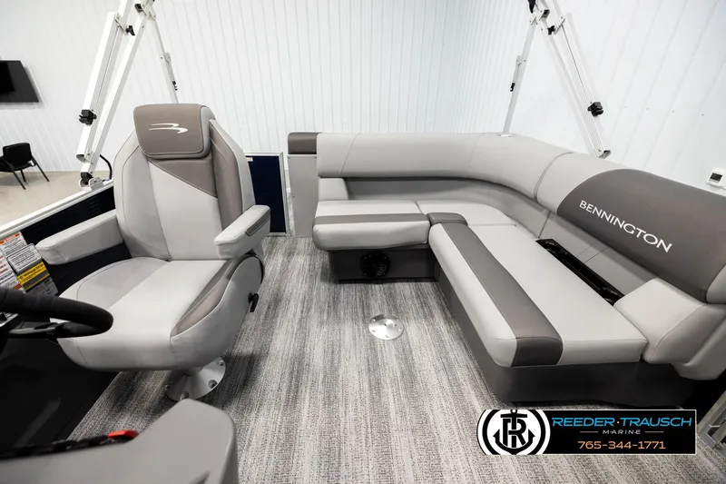 Slide: The Image of 2026 Bennington 188 SLJSE boat interior with gray seating and steering console. - 14
