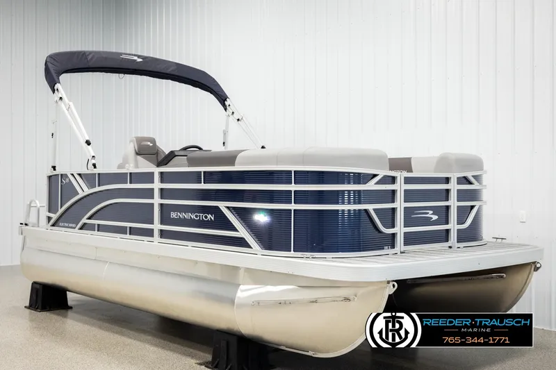 Slide: The Image of 2026 Bennington 188 SLJSE pontoon boat in showroom, featuring sleek design and modern amenities. - 2