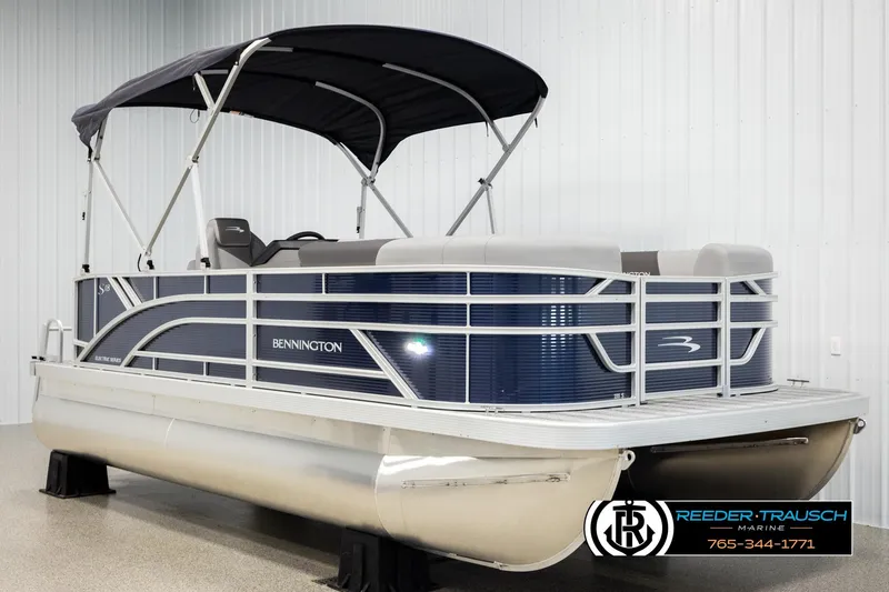 Slide: The Image of 2026 Bennington 188 SLJSE pontoon boat with canopy in showroom display. - 3