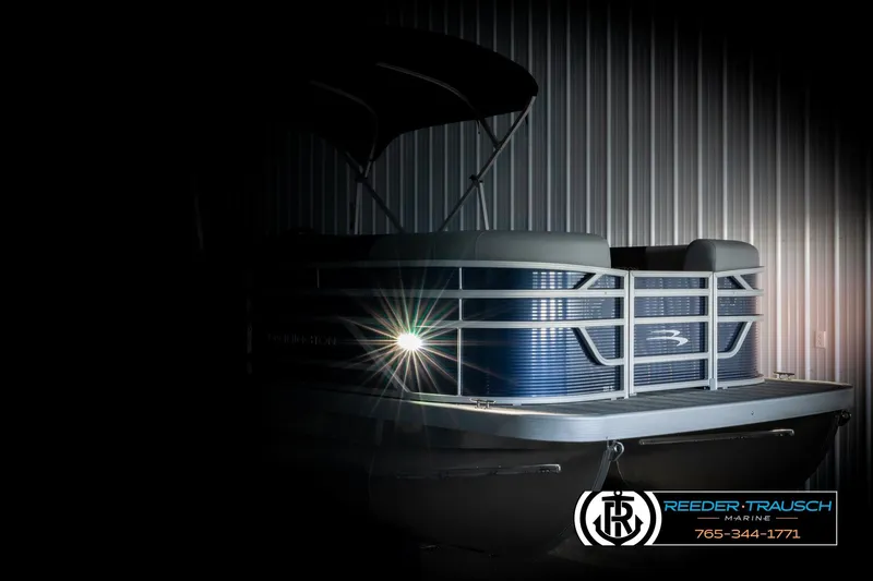 Slide: The Image of 2026 Bennington 188 SLJSE pontoon boat with illuminated headlight in a dimly lit setting. - 4