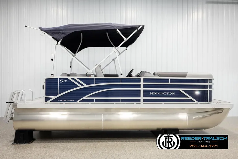 Slide: The Image of 2026 Bennington 188 SLJSE pontoon boat with canopy, displayed indoors. - 5