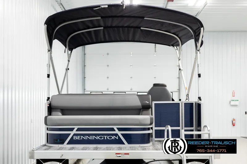 Slide: The Image of 2026 Bennington 188 SLJSE pontoon boat with canopy in a showroom. - 7