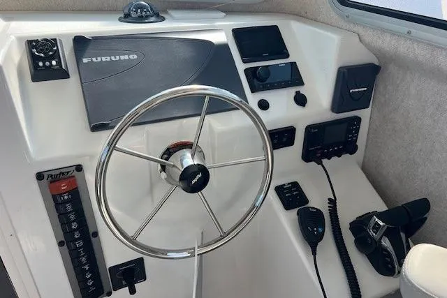 Slide: The Image of 2023 Parker 2820 XLD Sport Cabin helm with steering wheel and navigation equipment. - 17