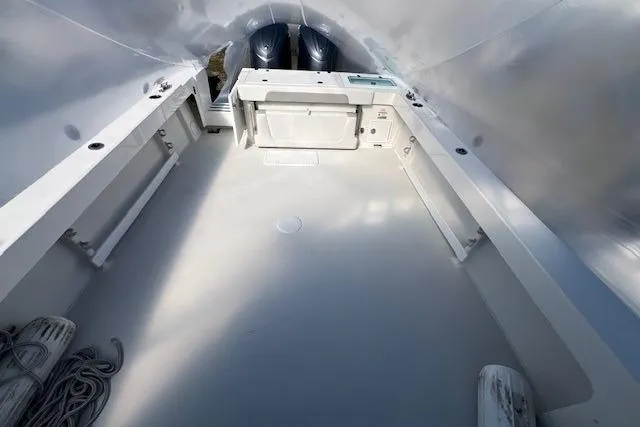 Slide: The Image of 2023 Parker 2820 XLD Sport Cabin boat interior with spacious deck and twin engines. - 18