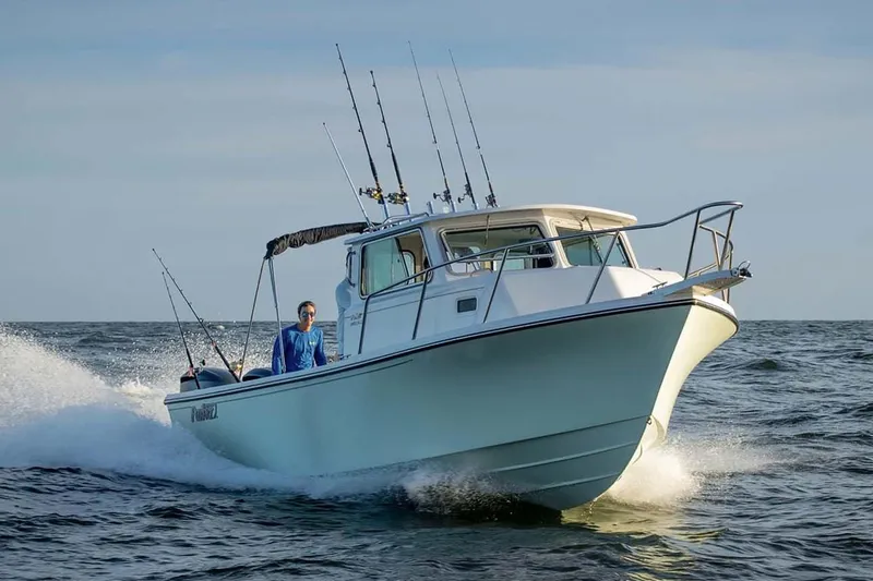Slide: The Image of Manufacturer Provided Image: 2024 Parker 2820 XLD Sport Cabin boat cruising on the ocean. - 2