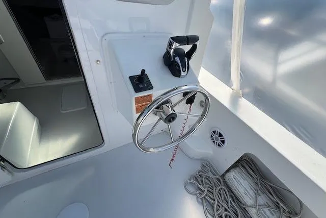 Slide: The Image of 2023 Parker 2820 XLD Sport Cabin helm with steering wheel and controls. - 24