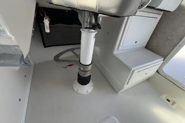 Slide: The Image of Interior of 2023 Parker 2820 XLD Sport Cabin boat, featuring seating and storage. - 25