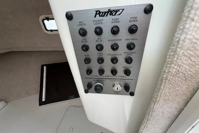 Slide: The Image of Control panel of 2023 Parker 2820 XLD Sport Cabin boat with labeled switches. - 27