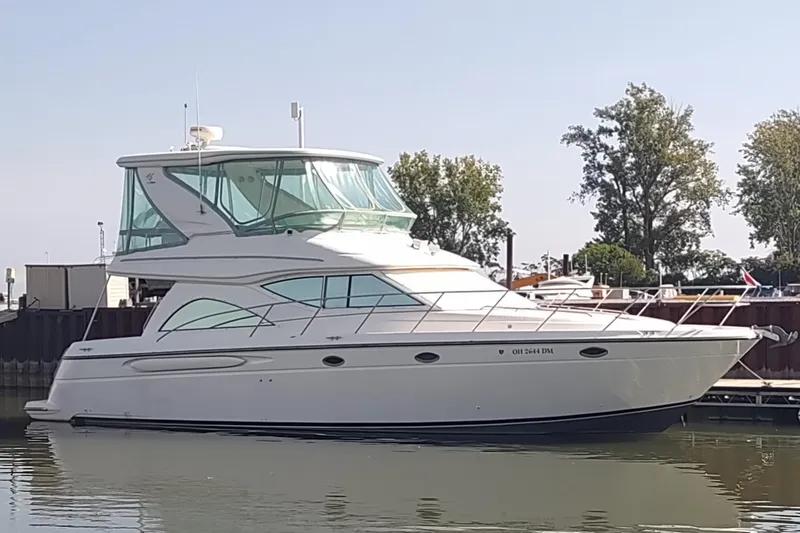 The Image of 2001 Maxum 4600 SCB yacht docked in a marina, side view. - 0