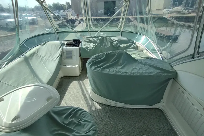 Slide: The Image of Interior of 2001 Maxum 4600 SCB yacht with covered seating and clear windows. - 10