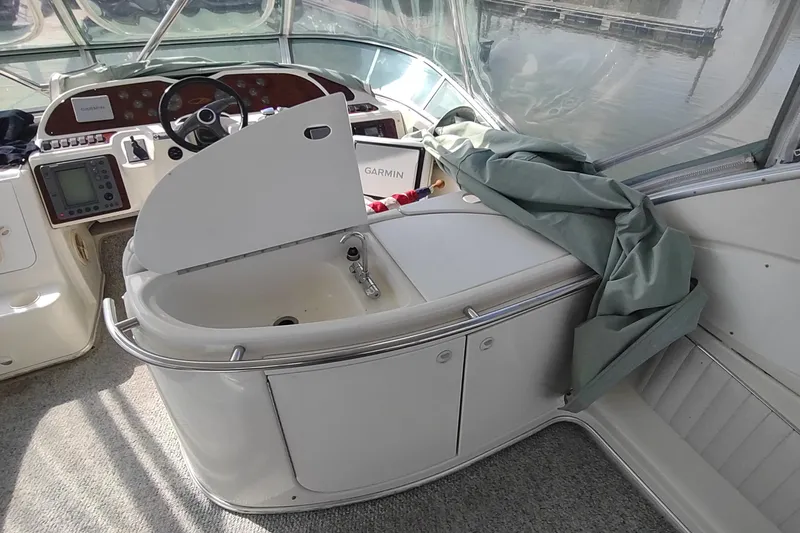 Slide: The Image of 2001 Maxum 4600 SCB yacht cockpit with steering wheel, navigation equipment, and sink. - 13