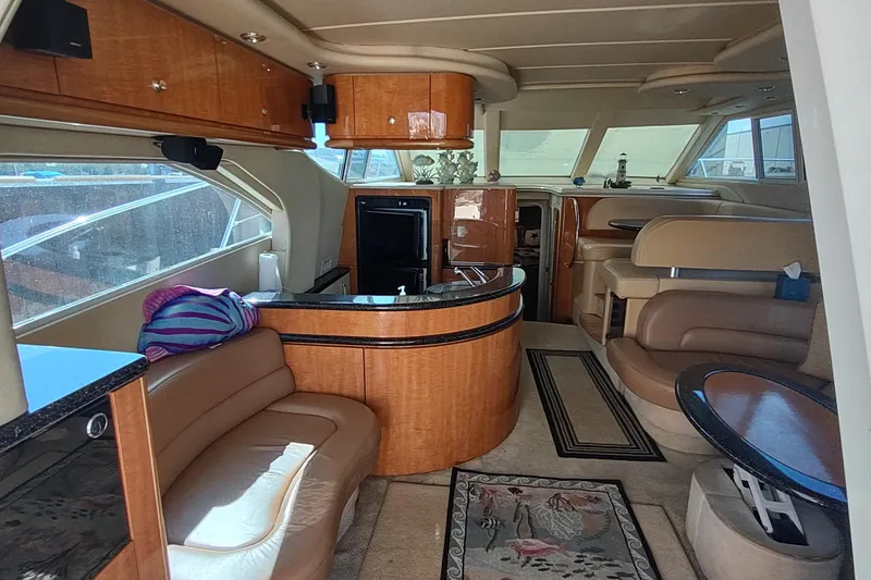 Slide: The Image of Luxurious interior of 2001 Maxum 4600 SCB yacht with elegant seating and wood finishes. - 2