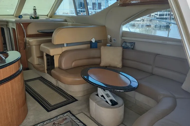 Slide: The Image of Luxurious interior of 2001 Maxum 4600 SCB yacht with elegant seating and table. - 21