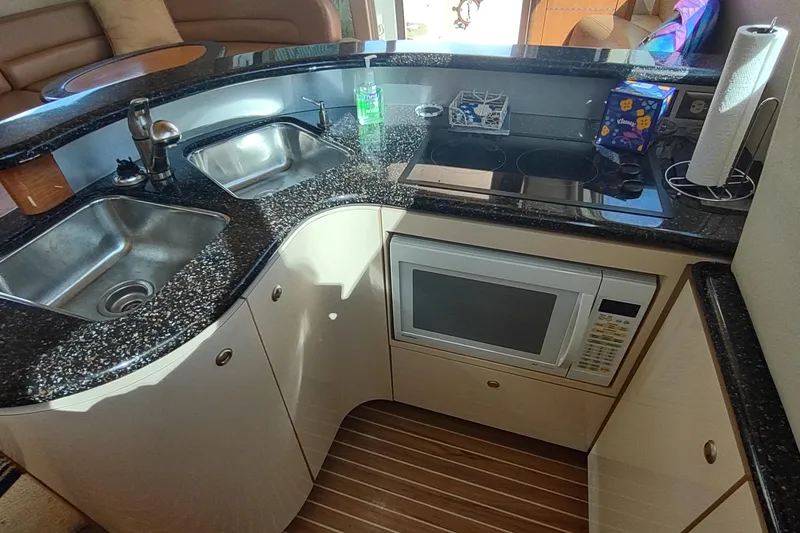 Slide: The Image of Luxurious 2001 Maxum 4600 SCB yacht kitchen with granite countertops and modern appliances. - 26