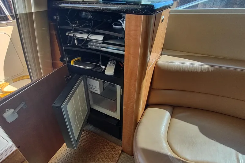 Slide: The Image of Interior of 2001 Maxum 4600 SCB yacht with open cabinet and electronics. - 28