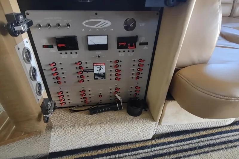 Slide: The Image of Control panel of a 2001 Maxum 4600 SCB yacht, featuring switches and gauges. - 29