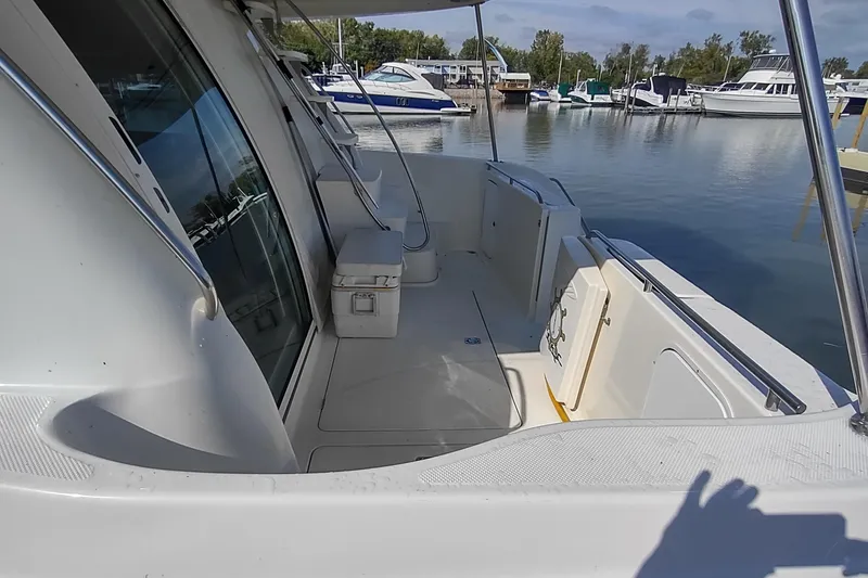 Slide: The Image of 2001 Maxum 4600 SCB yacht deck with seating, docked at marina. - 3