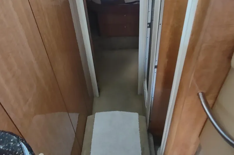Slide: The Image of Interior hallway of 2001 Maxum 4600 SCB yacht with wooden paneling. - 32