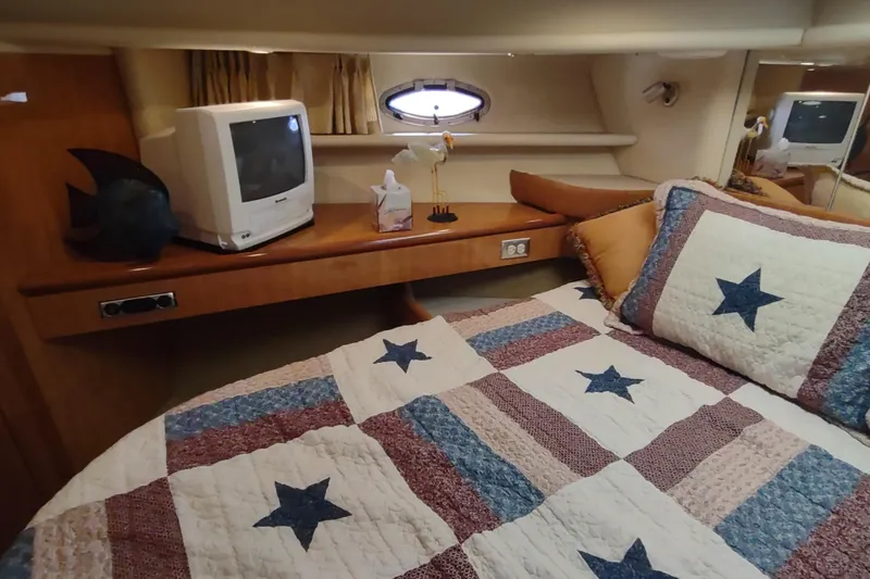 Slide: The Image of Cozy cabin interior of 2001 Maxum 4600 SCB with star-patterned quilt and vintage TV. - 35
