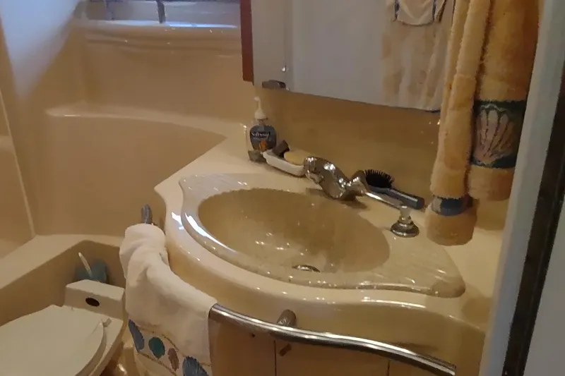 Slide: The Image of Bathroom interior of 2001 Maxum 4600 SCB yacht with sink and toiletries. - 36