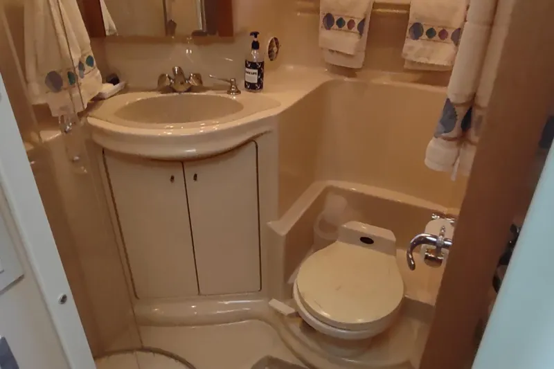 Slide: The Image of 2001 Maxum 4600 SCB yacht bathroom with sink, toilet, and towels. - 42