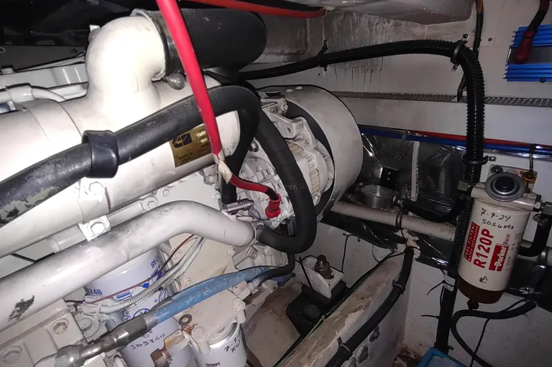 Slide: The Image of Engine room of a 2001 Maxum 4600 SCB yacht, showcasing mechanical components and wiring. - 51