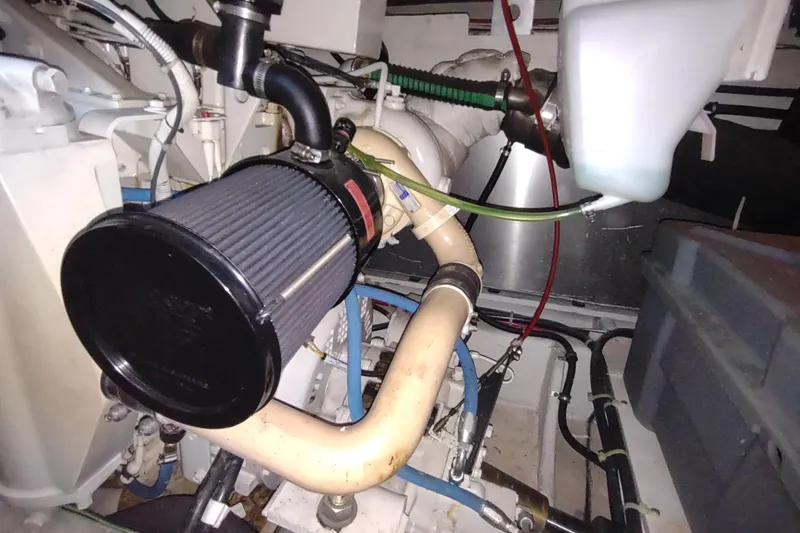 Slide: The Image of Engine compartment of 2001 Maxum 4600 SCB yacht, showcasing mechanical components and piping. - 56