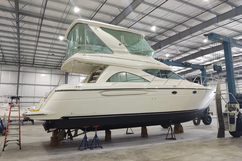 Slide: The Image of 2001 Maxum 4600 SCB yacht in a spacious indoor storage facility. - 6