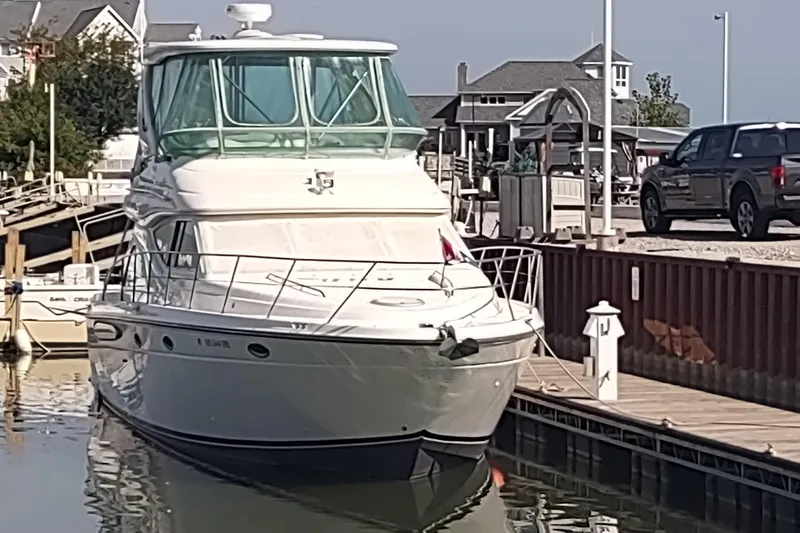 Slide: The Image of 2001 Maxum 4600 SCB yacht docked at a marina on a sunny day. - 7