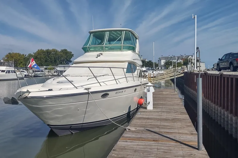 Slide: The Image of 2001 Maxum 4600 SCB yacht docked at marina under blue sky. - 8