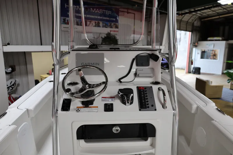 Slide: The Image of 2026 Parker 180 Coastal boat dashboard with Garmin navigation system and steering wheel. - 6