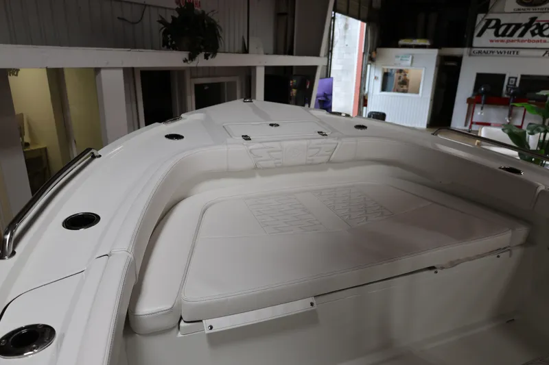 Slide: The Image of 2026 Parker 180 Coastal boat interior with white cushioned seating and stainless steel accents. - 9