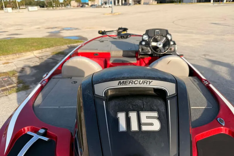Slide: The Image of Red Nitro Z17 boat with Mercury 115 engine, parked outdoors, 2018 model. - 6