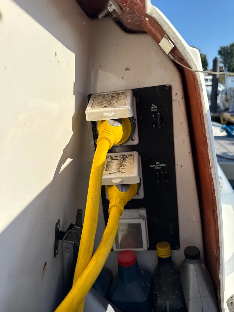 Slide: The Image of Yellow power cables connected to a 2004 Four 328 Vista boat's shore power outlet. - 11