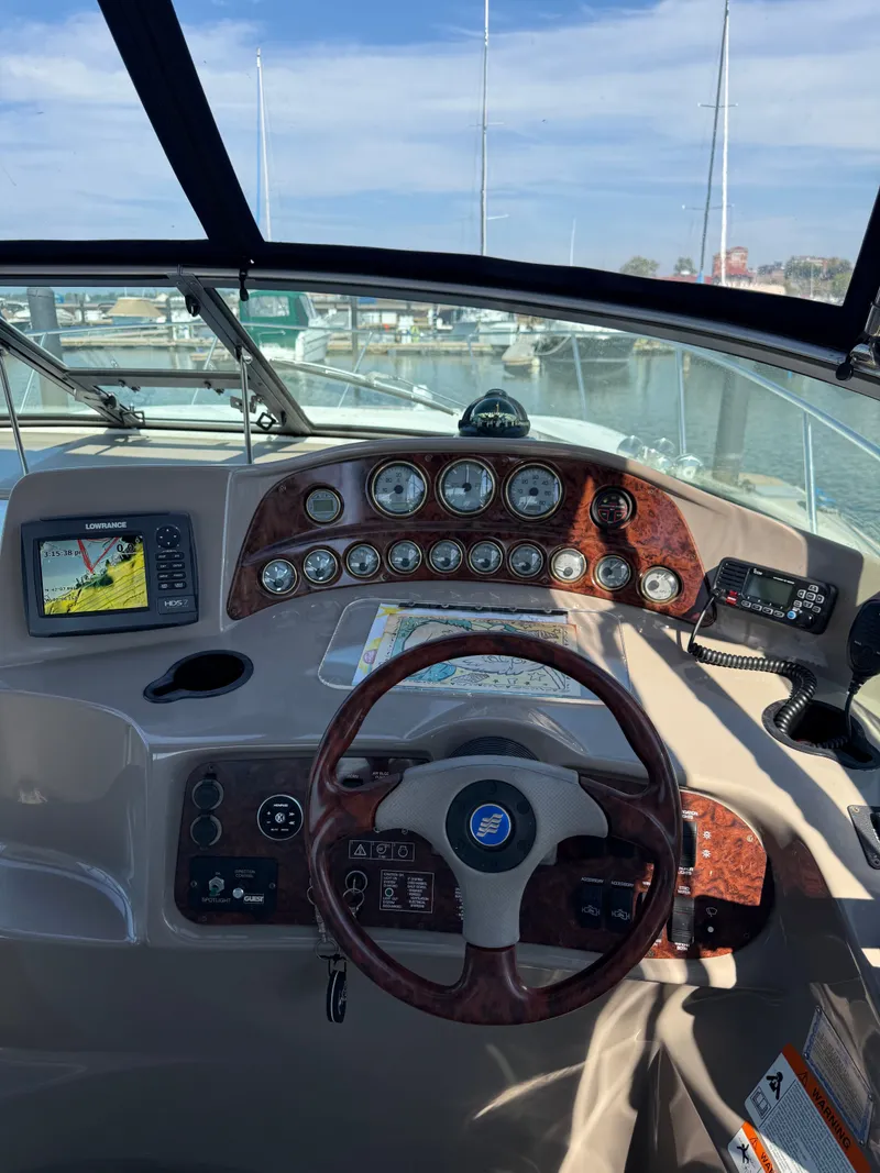 Slide: The Image of Boat dashboard of 2004 Four 328 Vista with navigation system and gauges. - 14