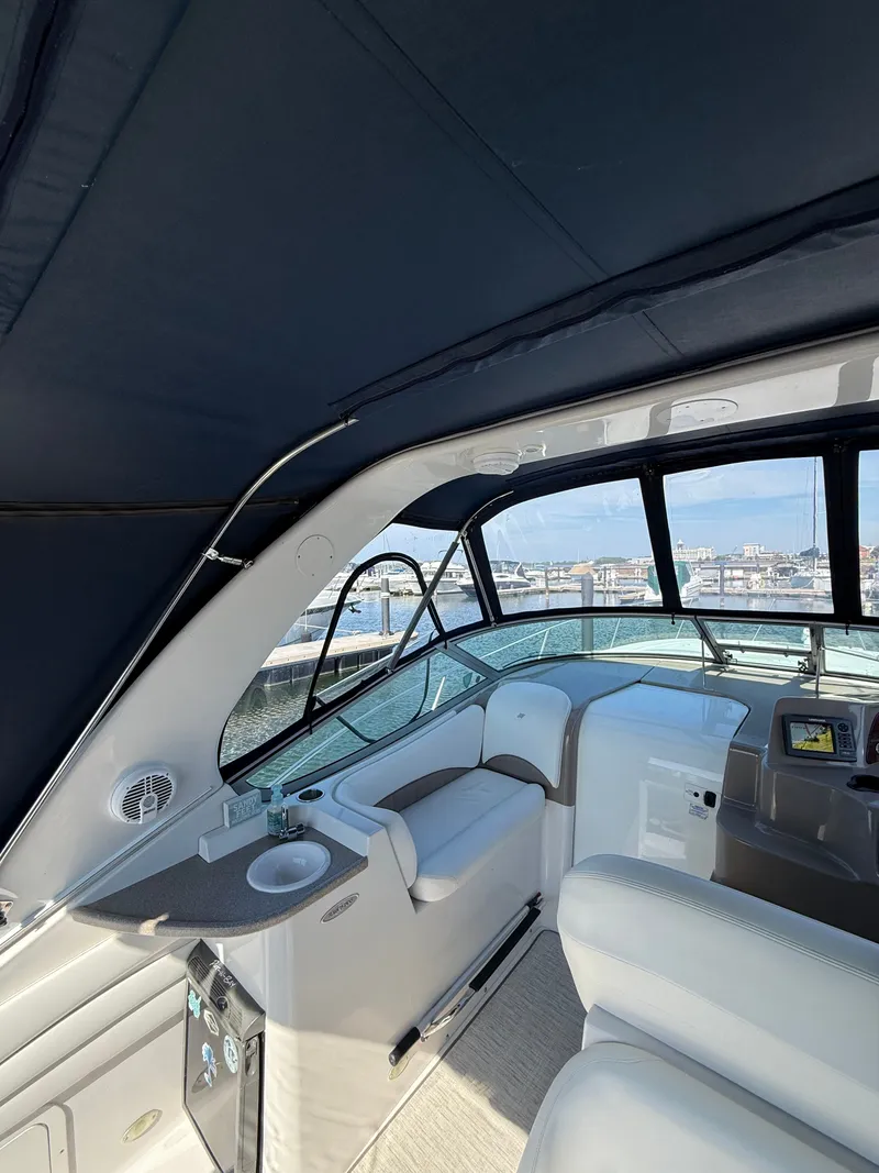 Slide: The Image of Interior of 2004 Four 328 Vista yacht with seating and control panel, docked at marina. - 16