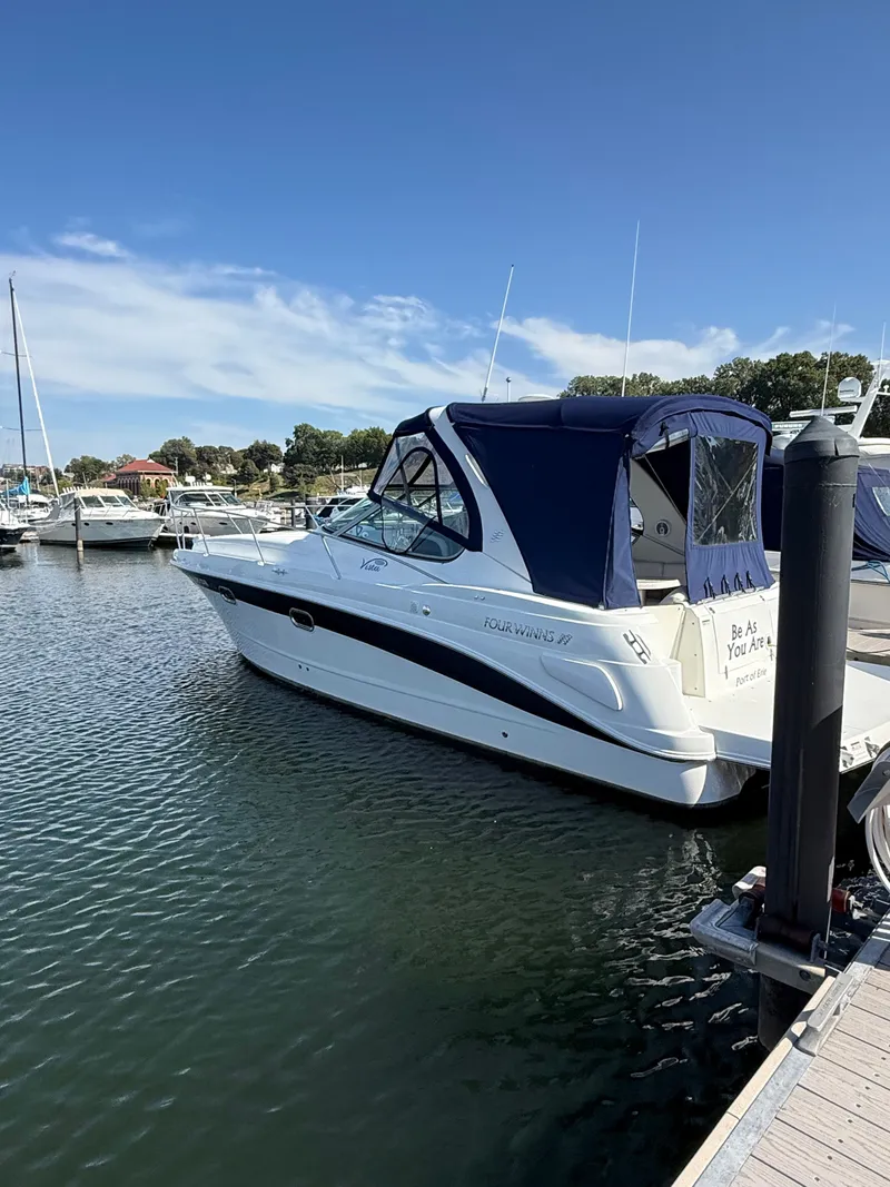 Slide: The Image of 2004 Four 328 Vista boat docked in a marina under a clear blue sky. - 17