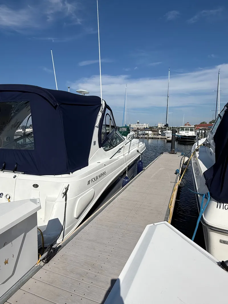 Slide: The Image of 2004 Four 328 Vista boat docked at marina under clear blue sky. - 18
