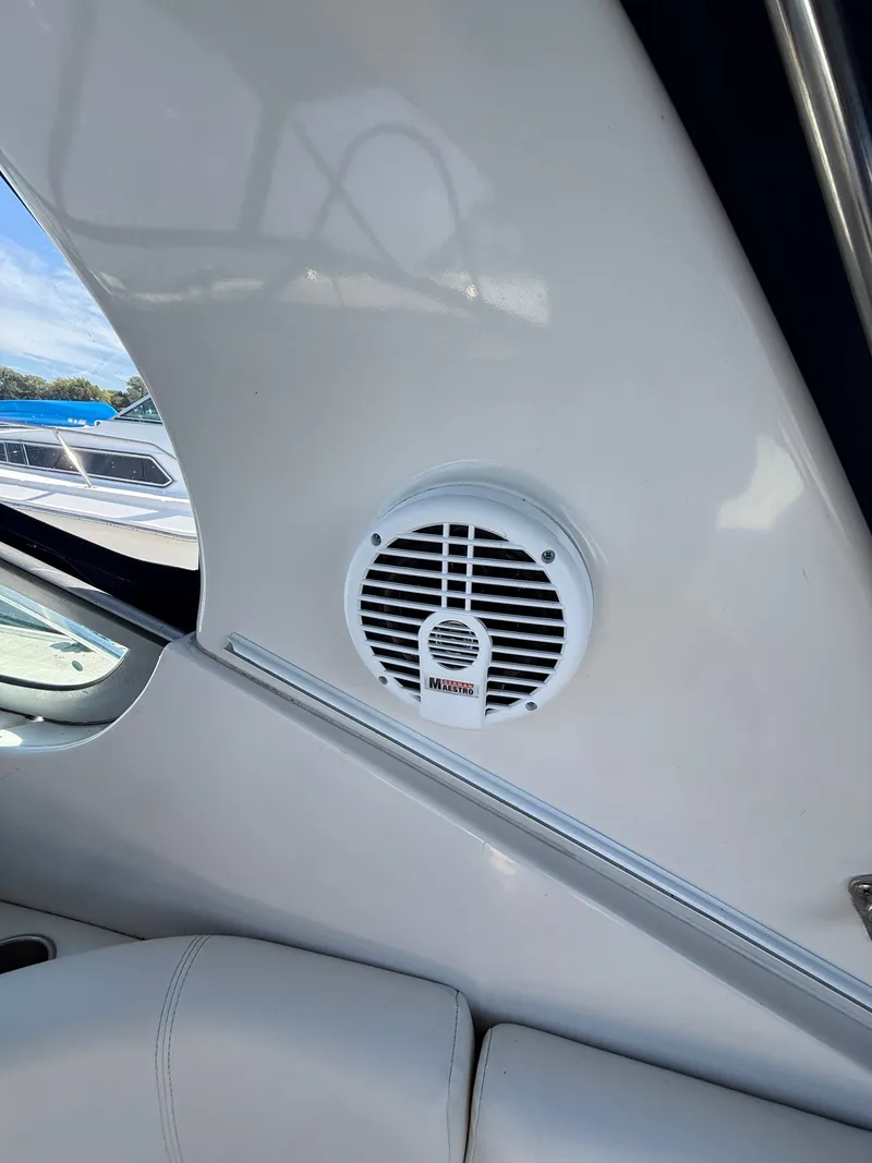 Slide: The Image of Boat interior with speaker on a 2004 Four 328 Vista, featuring white upholstery. - 21